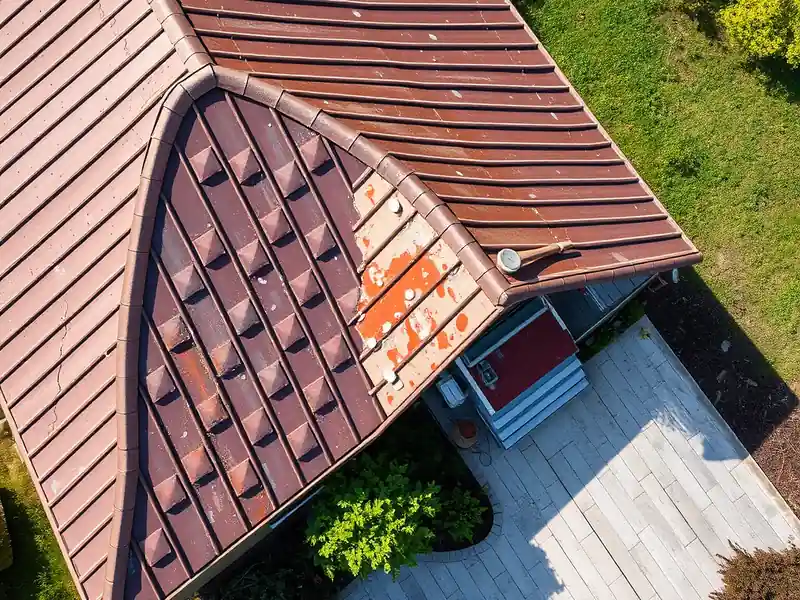 Illustration of close-up of materials and finishes of house with a standing-seam metal roof in a 1976-era home